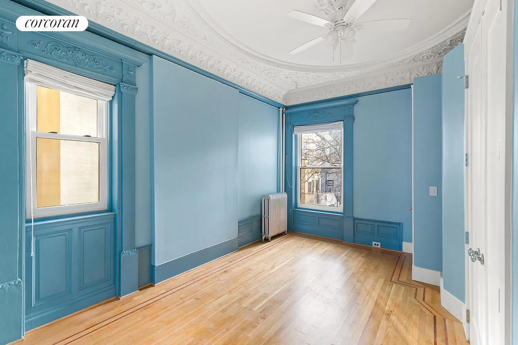 bedroom with blue walls, plasterwork, two exposures