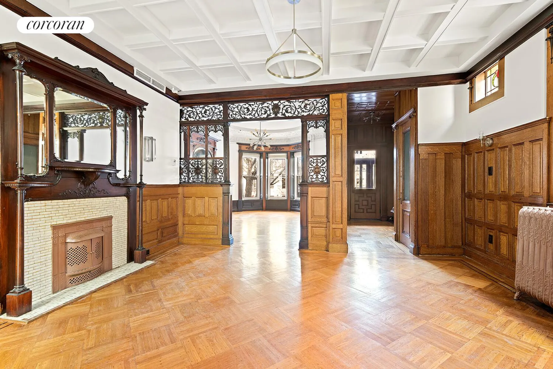dining room with fretwork, mantel with mirror, wainscoting