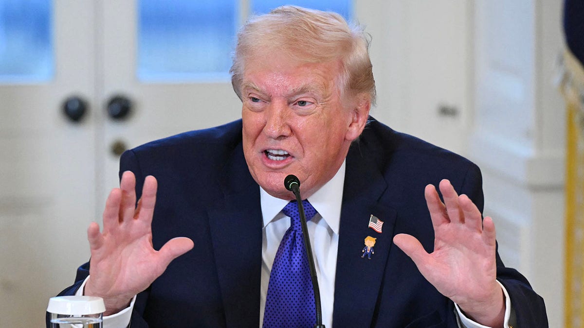 President Donald Trump talks to reporters