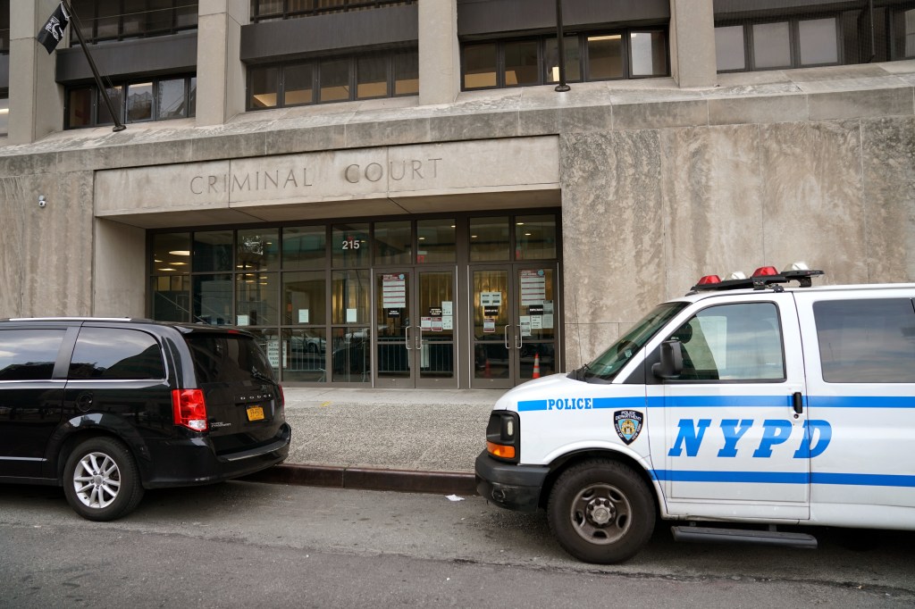 Bronx Criminal Court building at 215 East 161st Street with an NYPD police van parked outside.