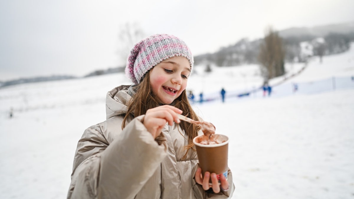 Girl drinking hot cocoa