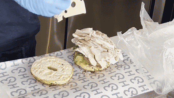 A GIF showing an H&H Bagel sandwich being made.
