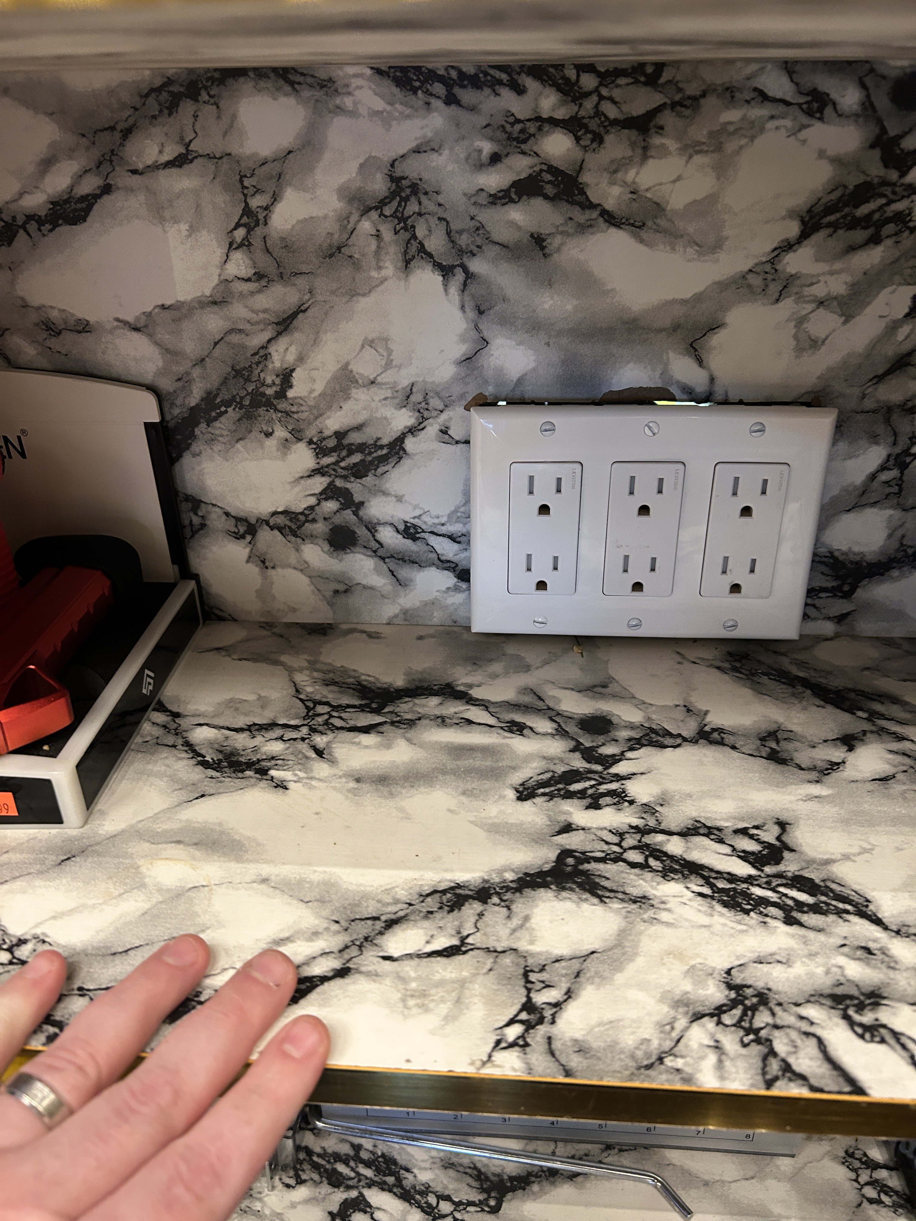 Inspectors found a storage area for the illicit cannabis product behind this electrical outlet in the store. 