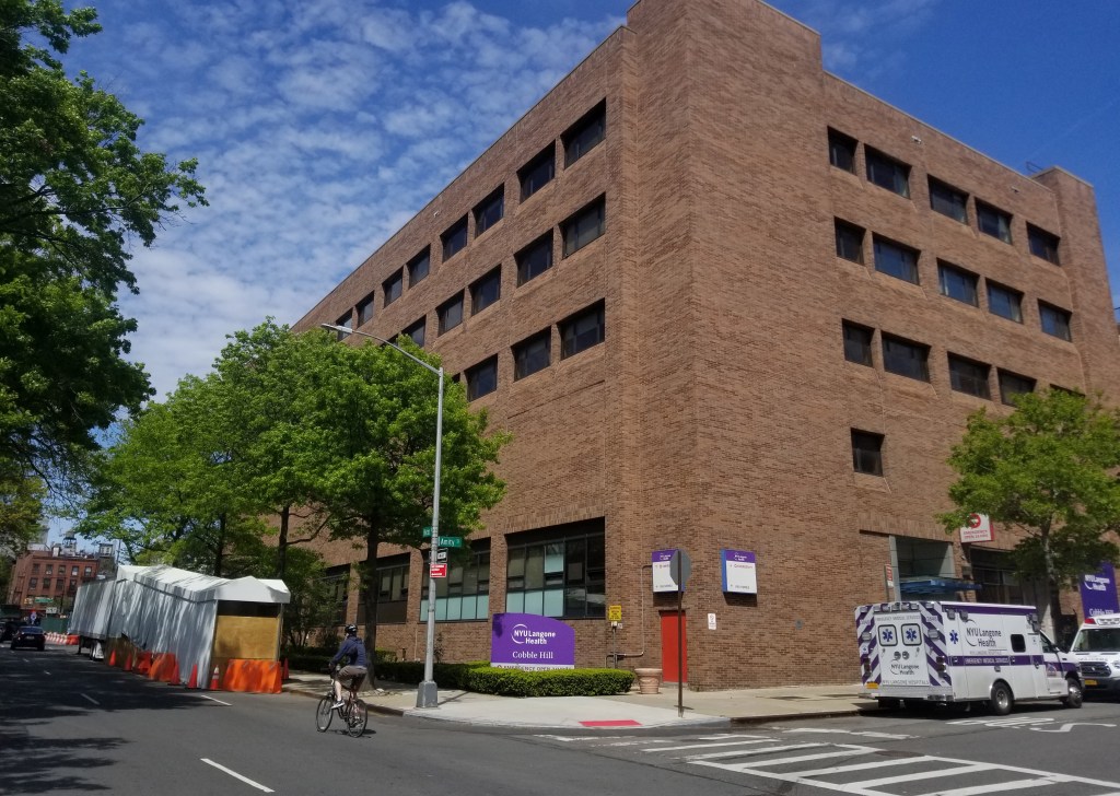 A refrigerated truck, serving as a makeshift morgue, is parked outside the NYU Langone Health Cobble Hill emergency department during the coronavirus pandemic.