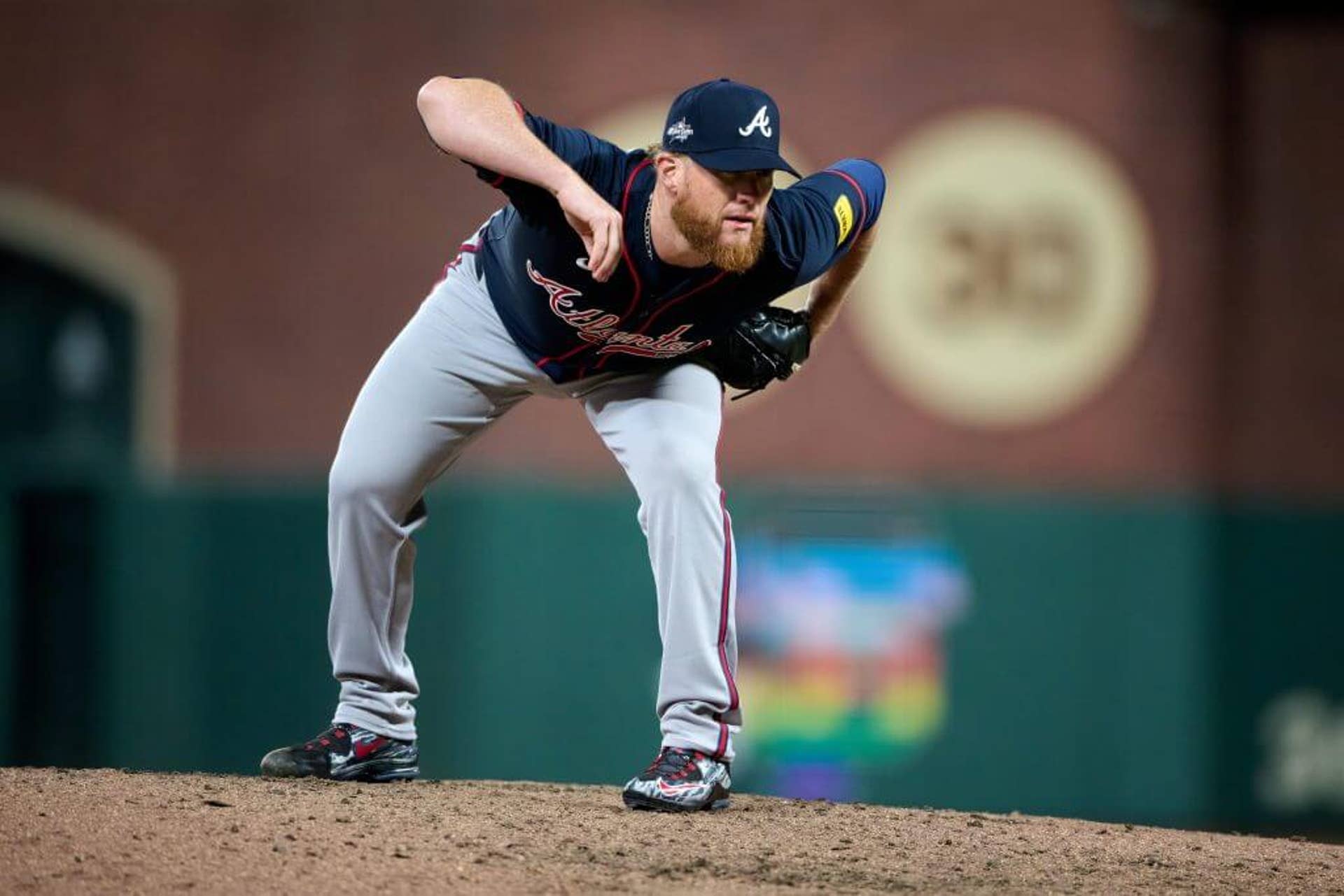 Atlanta Braves pitcher Craig Kimbrel looks at the catcher while holding out his right arm during a game against the San Francisco Giants.