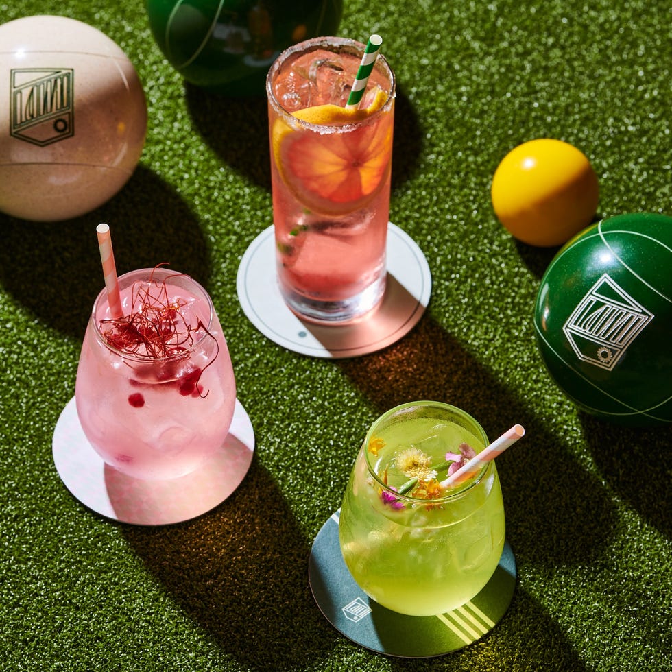 colorful cocktails and game balls on artificial grass
