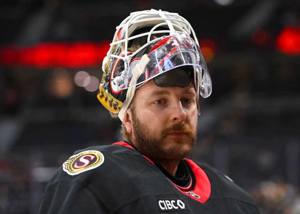 Headshot of Ottawa Senators player Linus Ullmark in a hockey helmet and jersey.