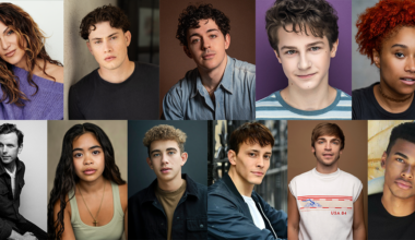 Woman with wavy brown hair and natural makeup wearing a lavender sweater, posing against a plain light background.