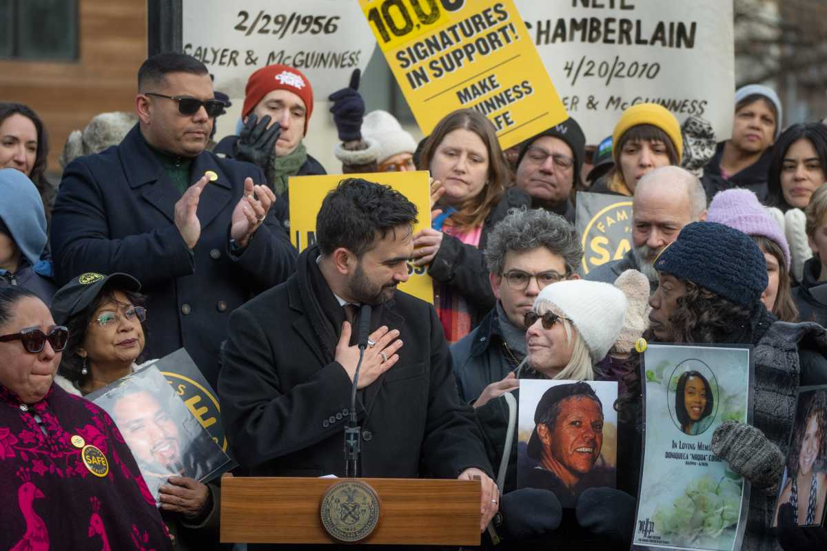 Mayor Mamdani hugging someone at McGuinness Boulevard press conference in Greenpoint Brooklyn