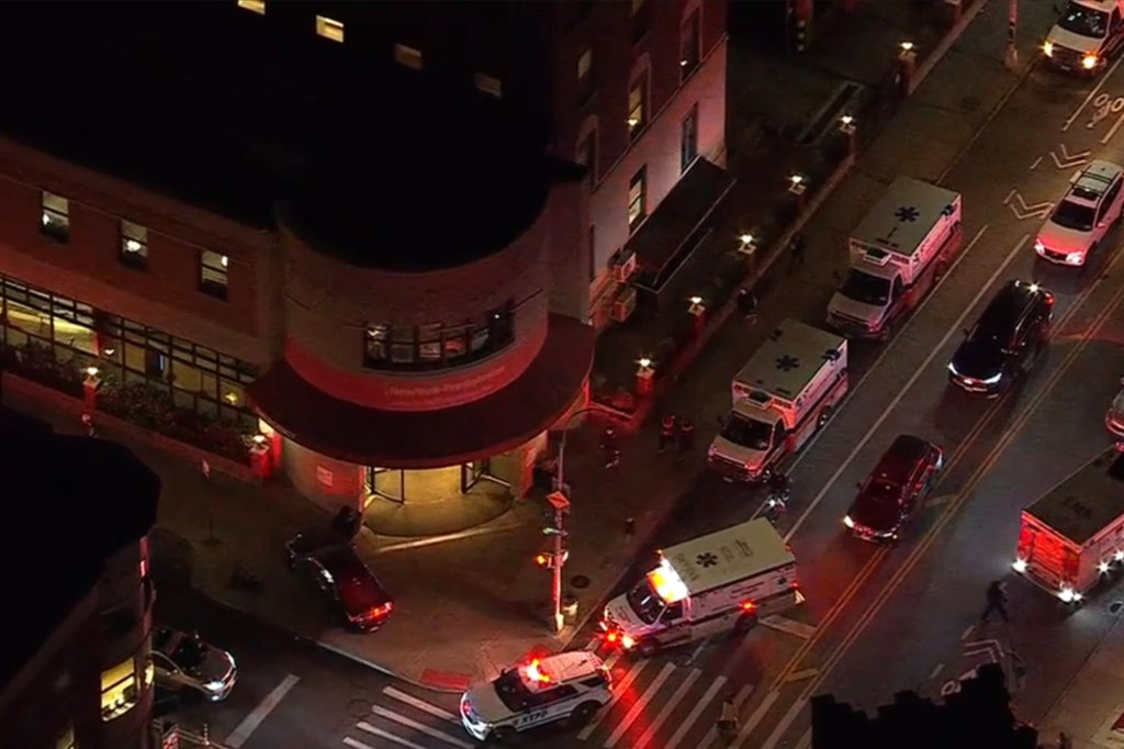 Aerial photo of NewYork-Presbyterian Brooklyn Methodist Hospital at night with multiple ambulances and police cars outside.