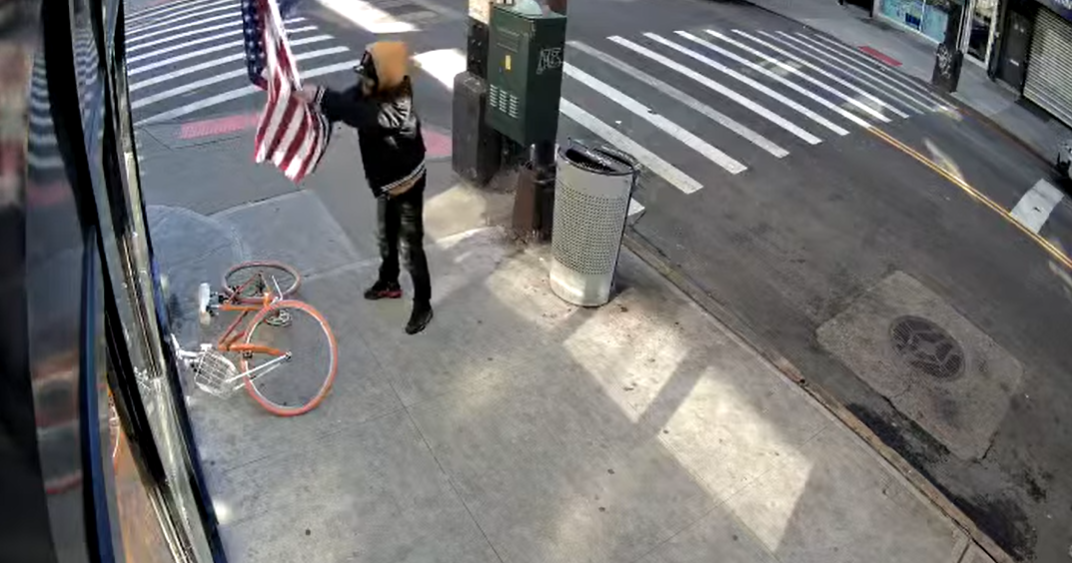 Video shows American flag being slashed "to ribbons" outside Queens bar