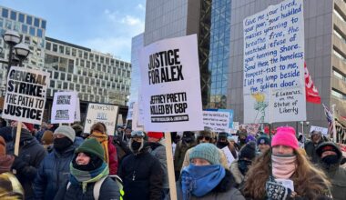 protesters hold signs in minneapolis
