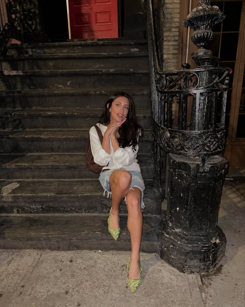 Musician Fia James sitting on a flight of dark steps.