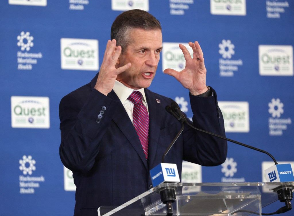 New New York Giants head coach John Harbaugh gestures while speaking at a press conference.