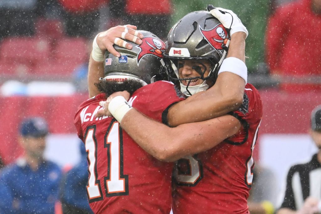 An image collage containing 1 images, Image 1 shows Tampa Bay Buccaneers tight end Cade Otton (88) celebrates his touchdown catch with wide receiver Jalen McMillan (11) during the first half of an NFL football game against the Carolina Panthers Saturday, Jan. 3, 2026, in Tampa, Fla