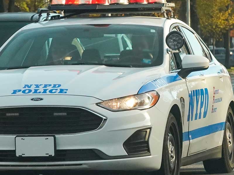NYPD police car with lights on