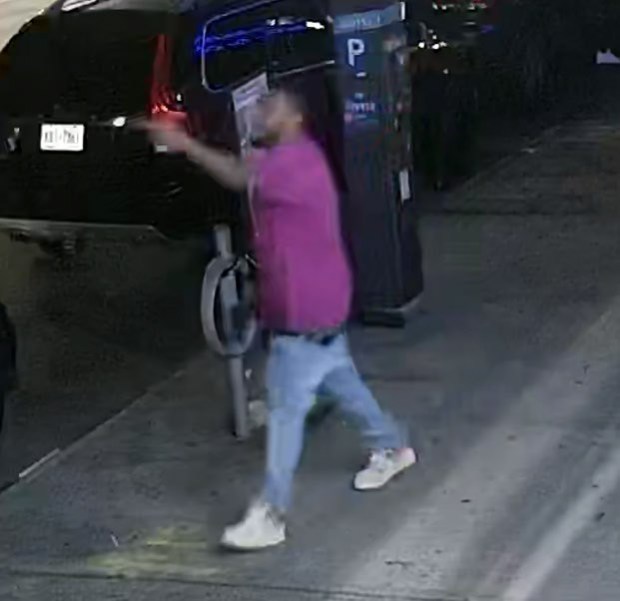 Still frame from a Red Sea security camera, showing Mr. Emile with a gun in his right hand as he was about to walk diagonally across Church Avenue toward East 53rd Street. (NY Attorney Generals Office) 