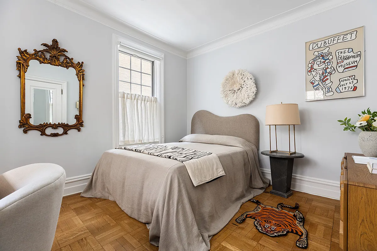 bedroom with wood floor, pale gray walls