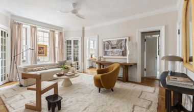 living room with built-in storage, wood floor