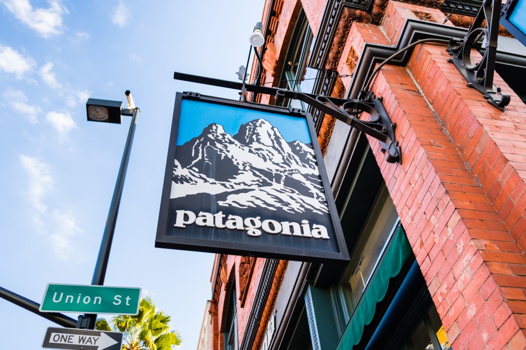 Patagonia sign with mountains and the company name on a brick building in Pasadena, California.