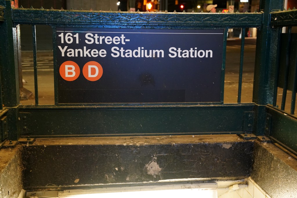 Subway entrance sign for 161 Street-Yankee Stadium Station with B and D train lines.