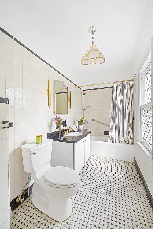 bathroom with white fixtures, tile floor