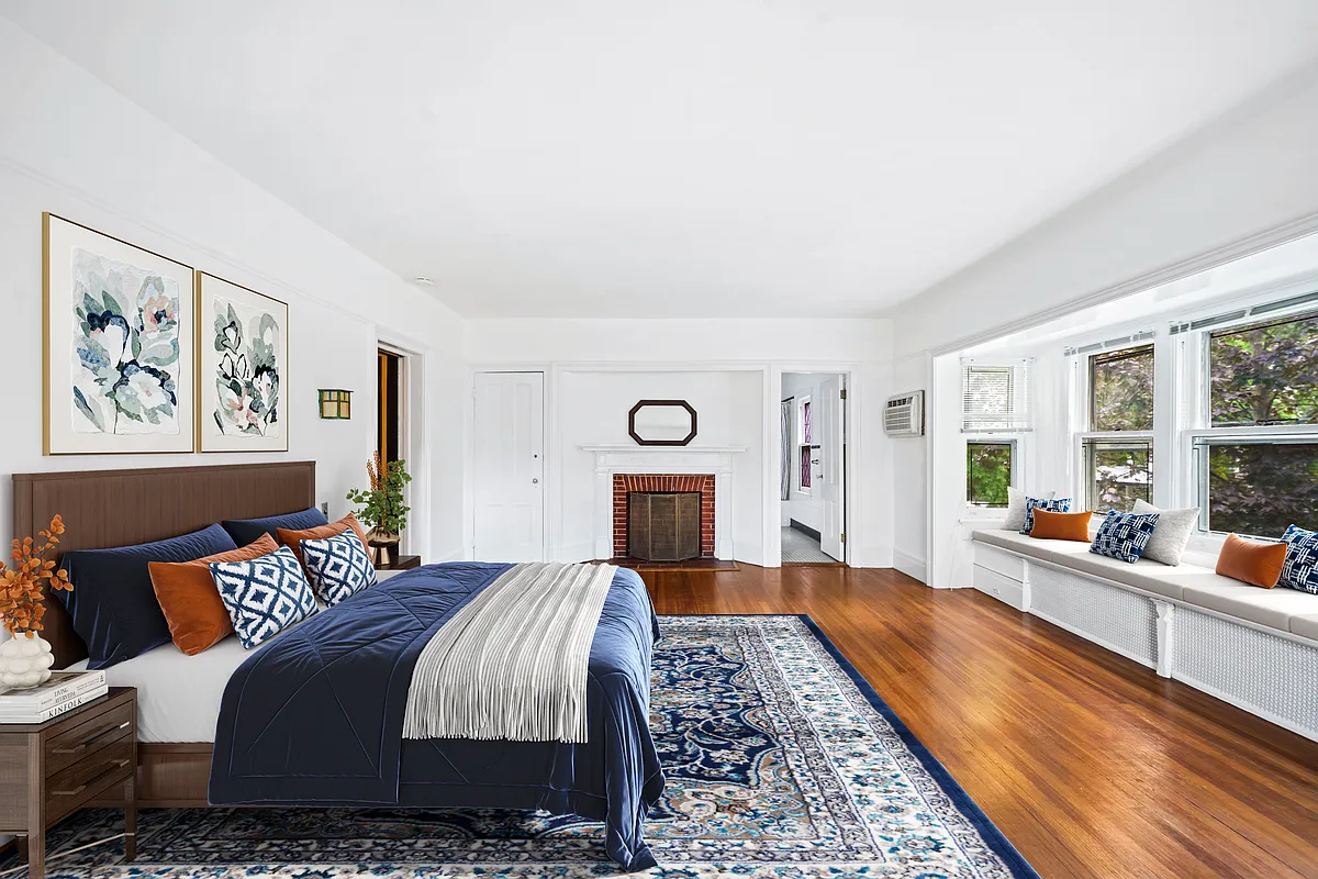 virtually staged bedroom with window seat, mantel