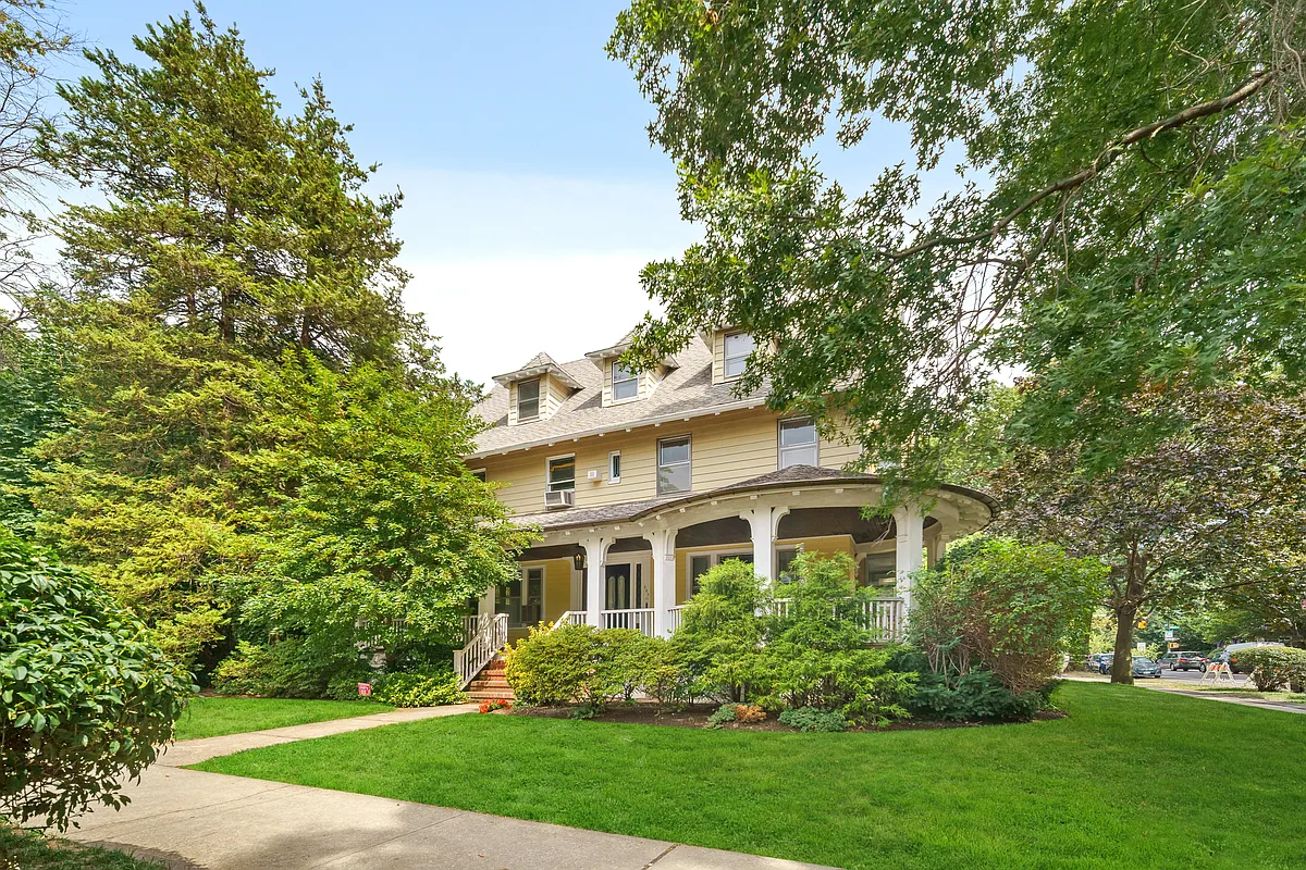 standalone house with curved wrap around porch