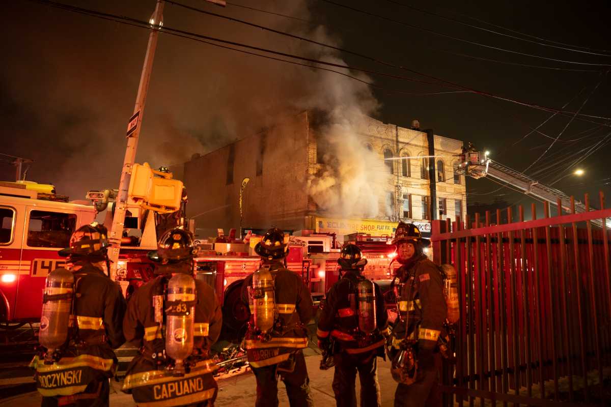 Queens three-alarm fire at tire shop and apartment building injures two firefighters – amNewYork