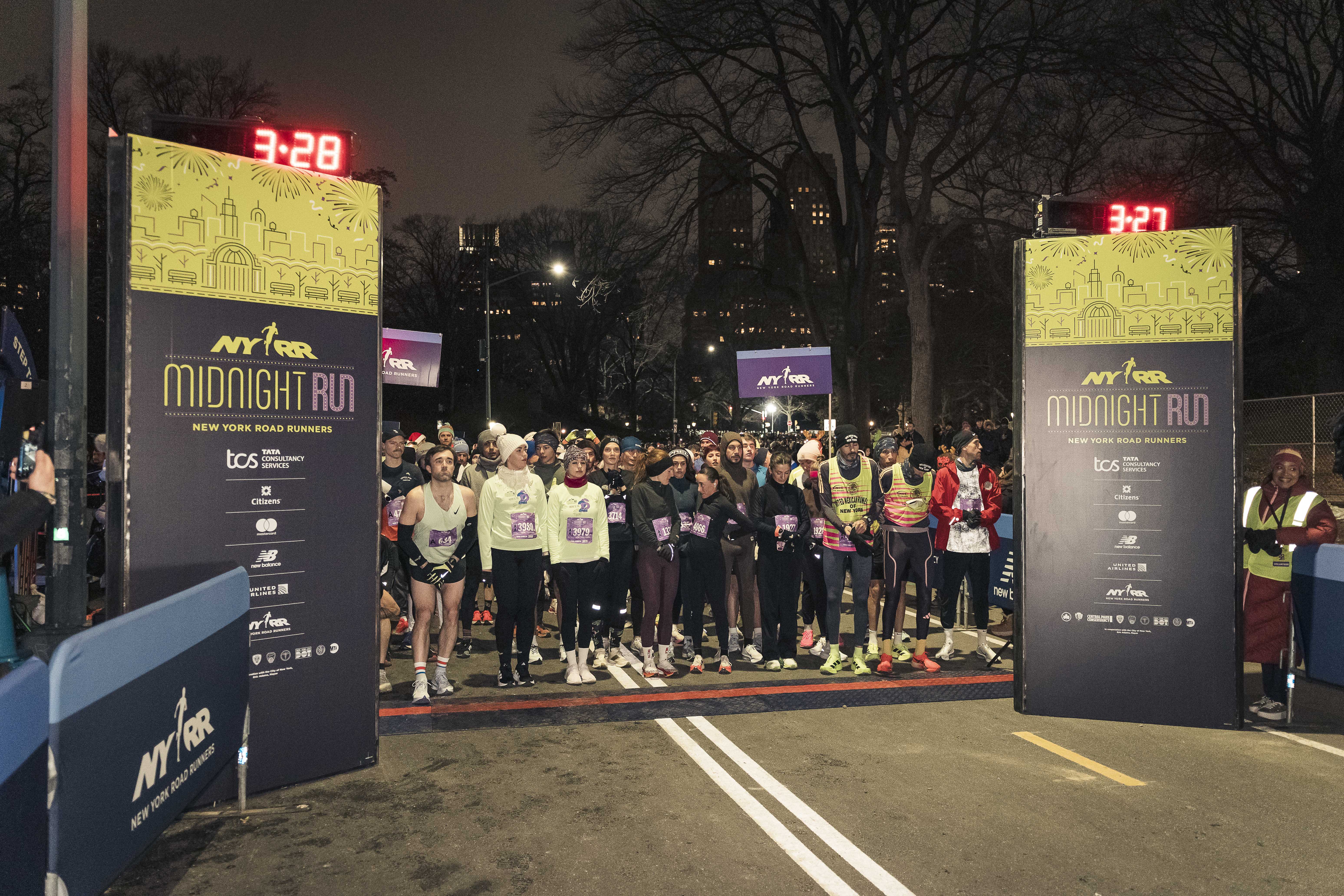 The countdown to midnight at the start line with runners lined up.