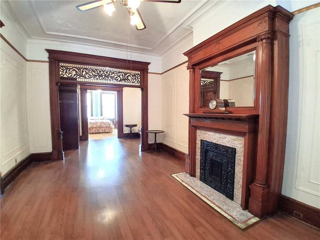 parlor with mantel, wall moldings, fretwork