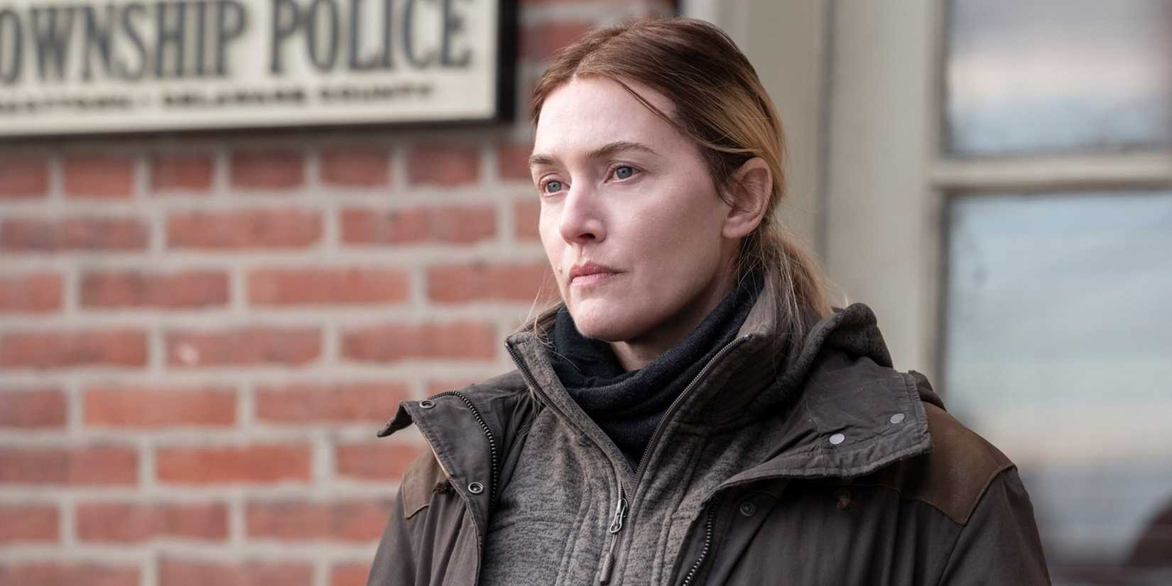 Kate Winslet stands outside the police station in Mare of Easttown.