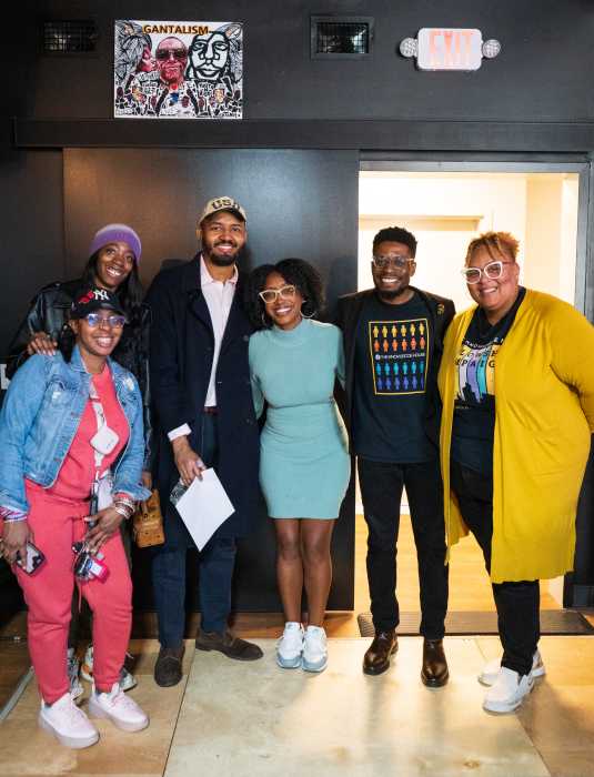 CEO and co-founder of TKH, poses with staff members and students from the organization’s Newark program.