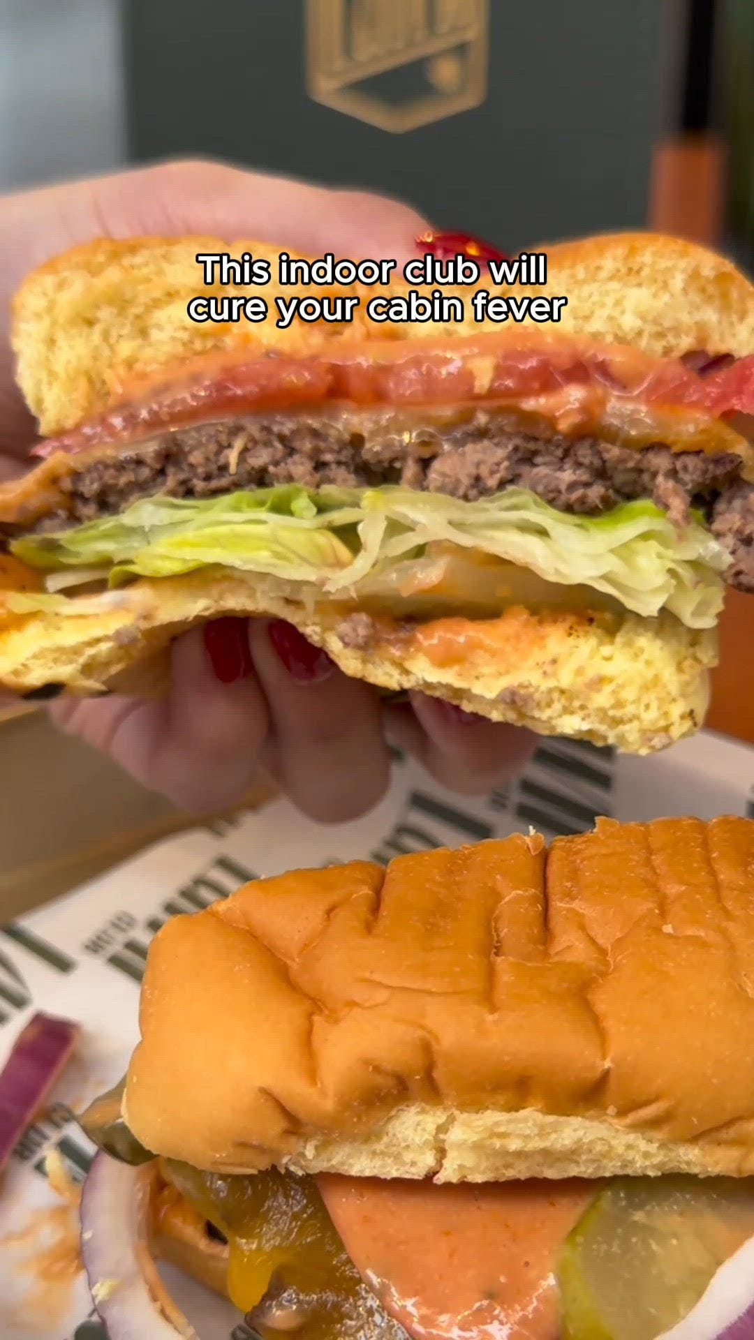 food platter featuring a chicken sandwich tater tots and a beer in a casual setting
