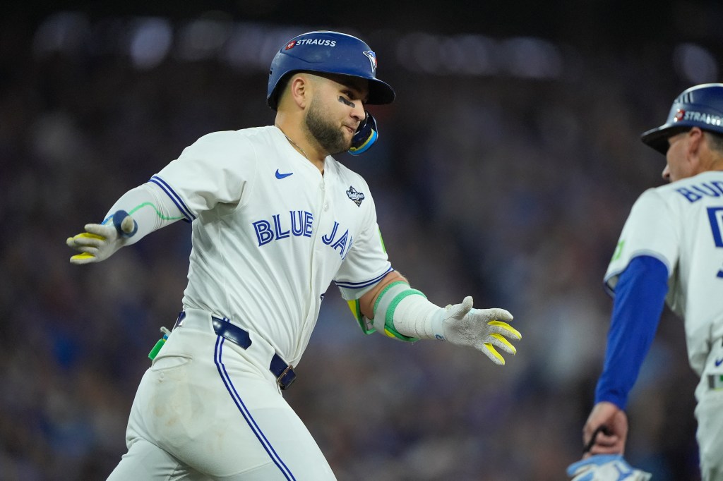 Toronto Blue Jays designated hitter Bo Bichette reacts after hitting a three-run home run.