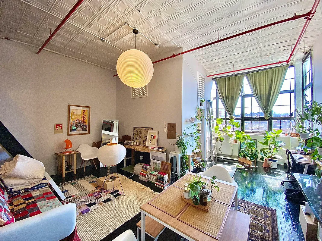 living area with corner windows, tin ceiling