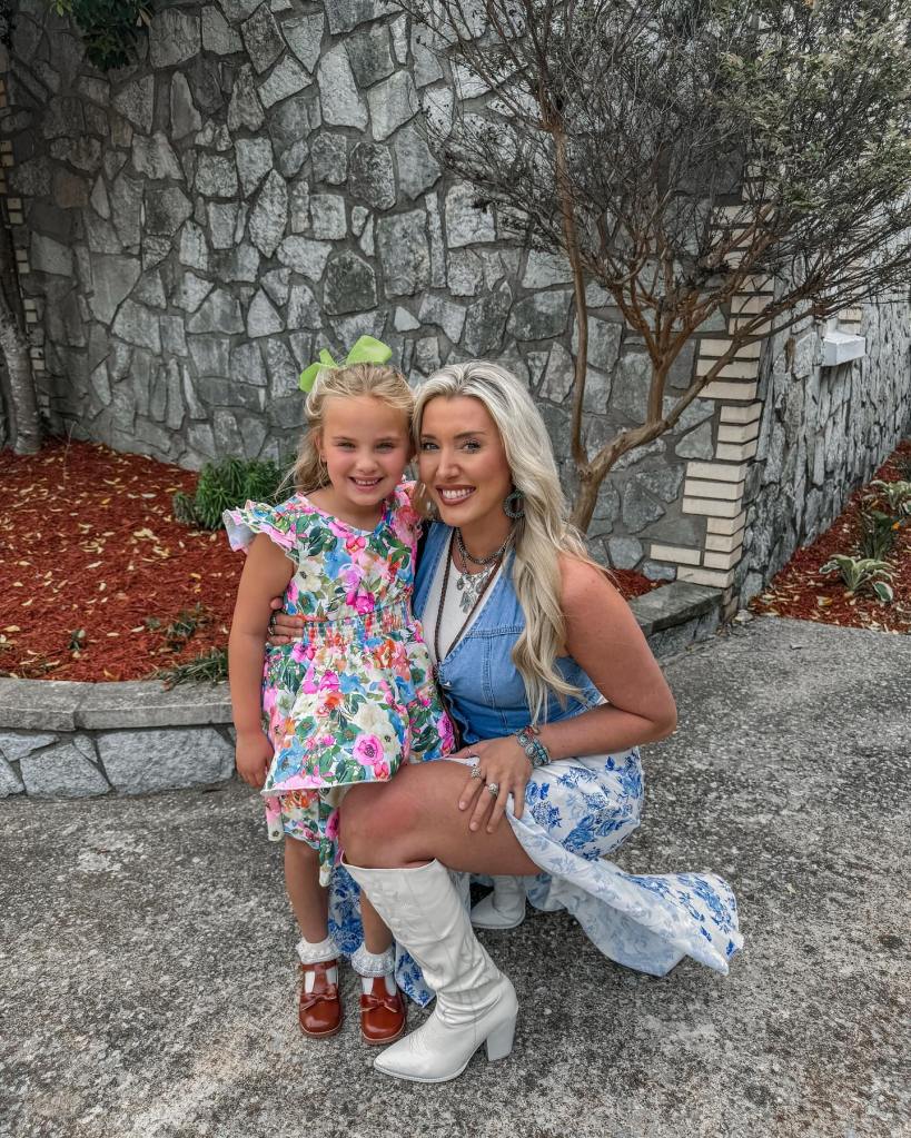 Lunden Roberts posing with her daughter Navy, who is wearing a floral dress.