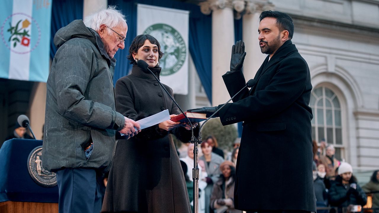 U.S. Sen. Bernie Sanders, I-Vt., left, administers the oath of office to Mayor Zohran Mamdani, right, as Rama Duwaji, center, holds the Quran during Mamdani's inauguration ceremony, Thursday, Jan. 1, 2026, in New York. (AP Photo/Andres Kudacki)