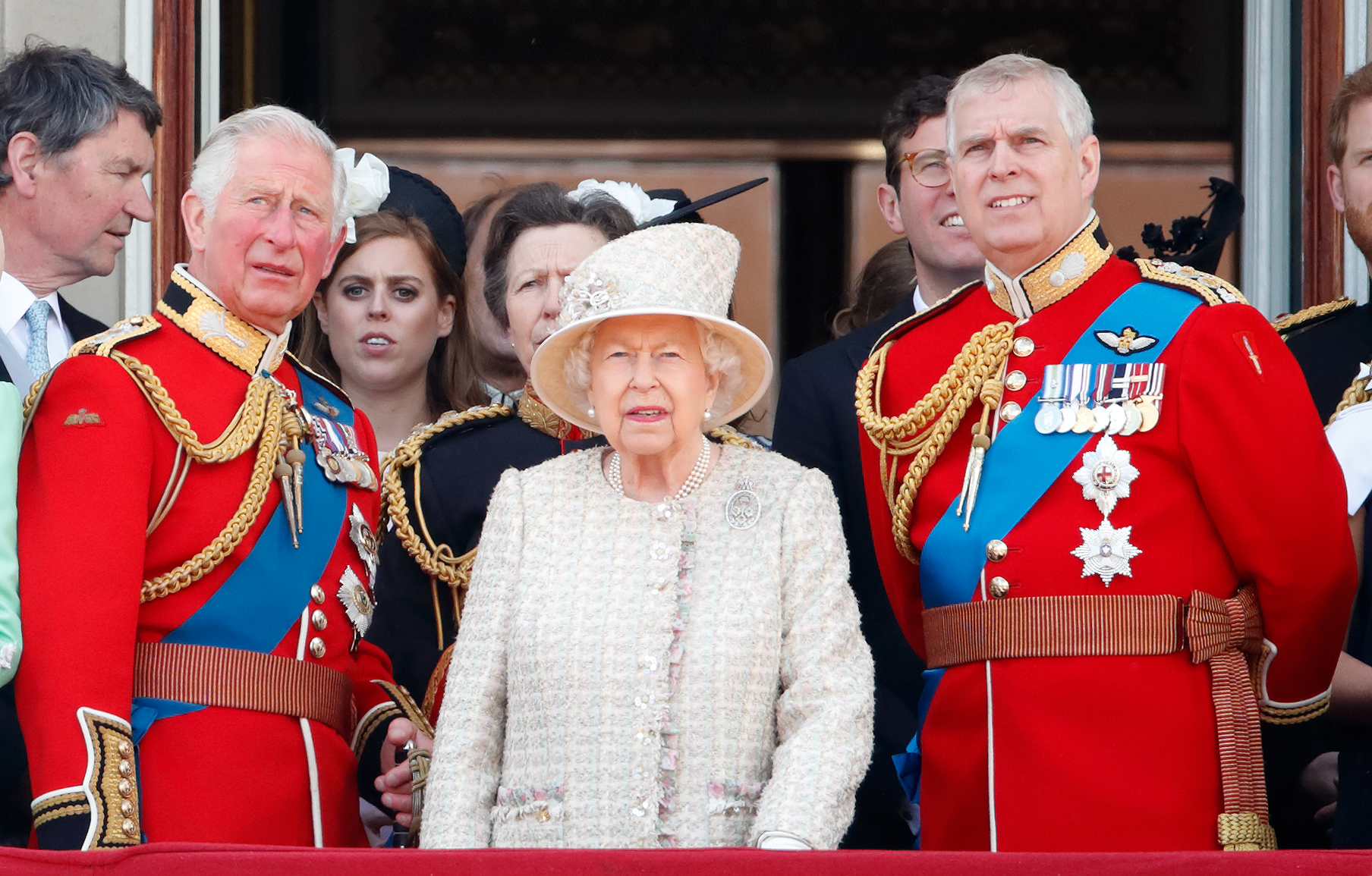 Queen Elizabeth II, Prince Charles, and Prince Andrew watch the Trooping The Colour parade from the balcony of Buckingham Palace.
