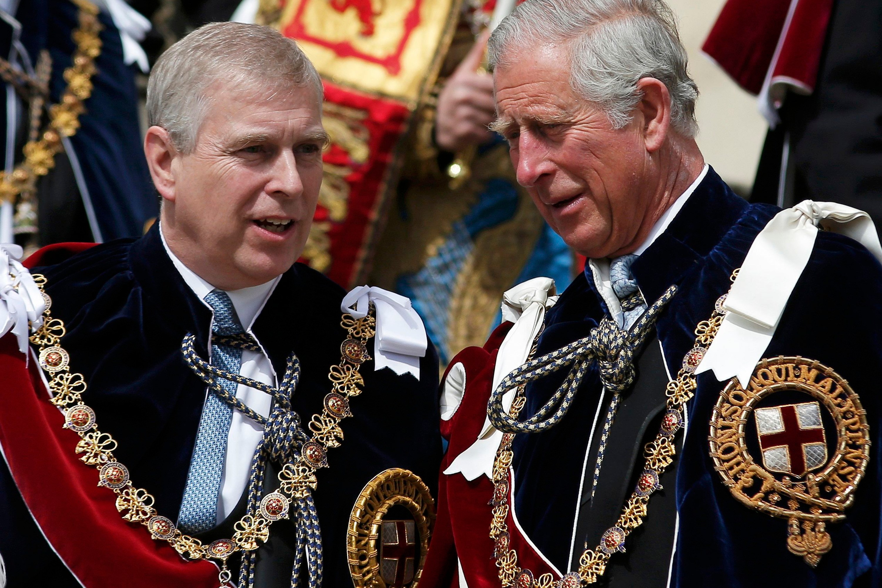 King Charles III and Prince Andrew wearing ceremonial robes and chains.