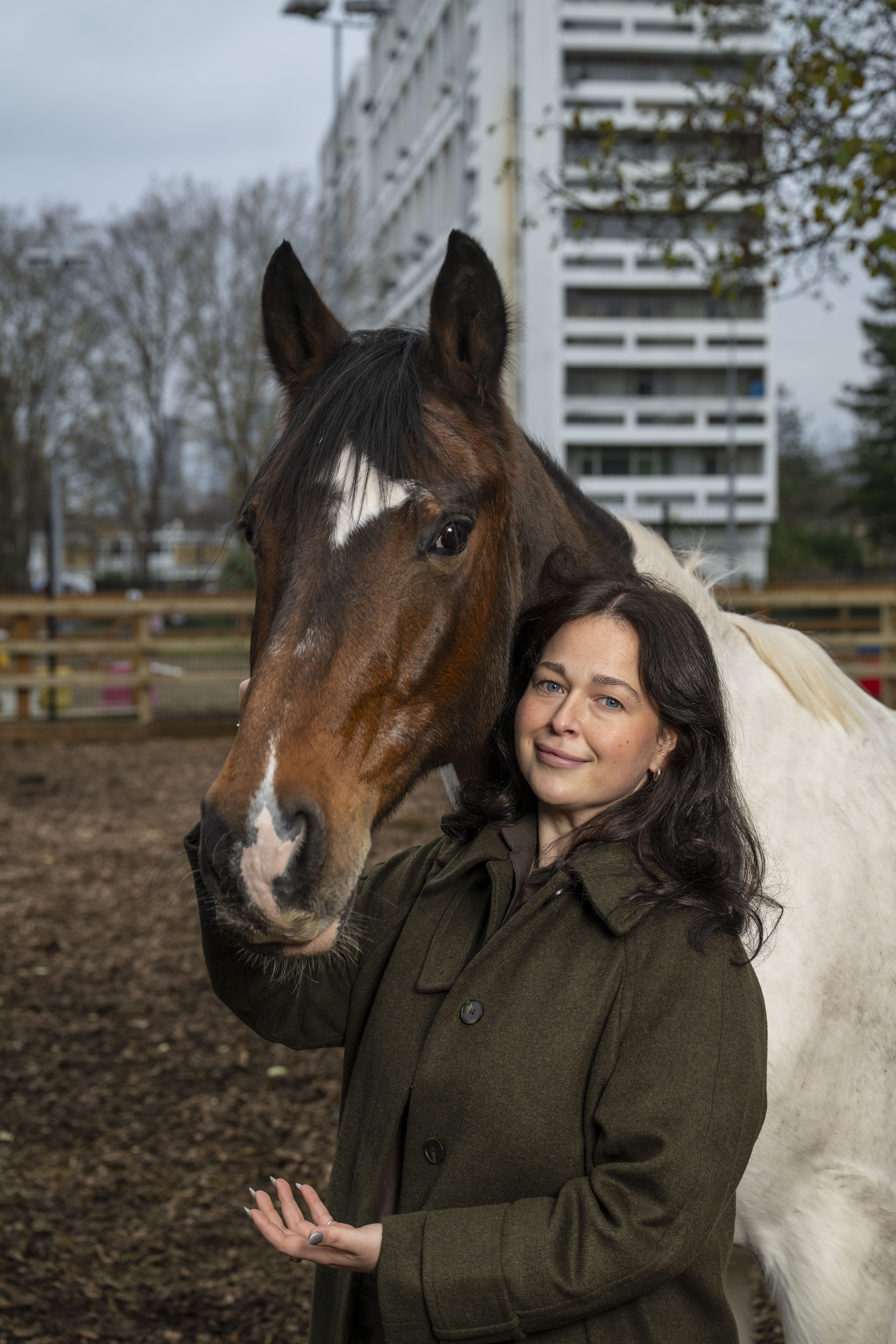 Sid Holdsworth, chief operating officer of Ebony Horse Club, standing next to a horse.