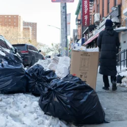 Piles of trash sat in the snow along Lafayette Avenue in Brooklyn, Feb. 2, 2026. Credit: Ben Fractenberg/THE CITY
