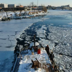 Tugboat operators N.D. Austin and Jean Barberis use the barge to help break up ice in Newtown Creek, Jan. 29, 2026. Credit: Alex Krales/THE CITY