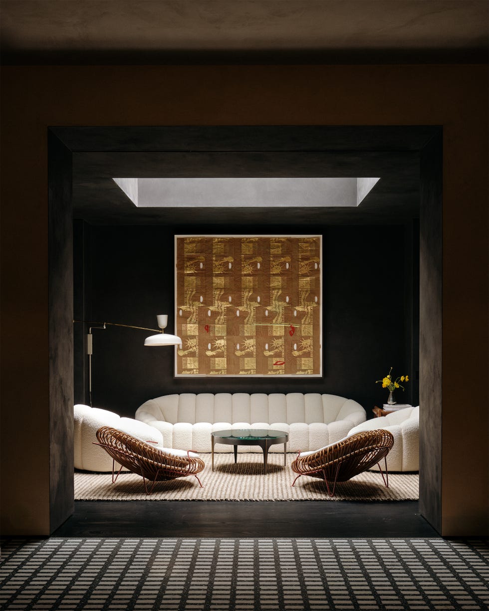 Modern lounge area with curved seating and decorative art.