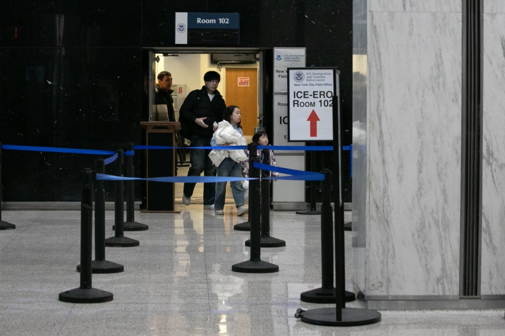 An immigrant family leaves an ICE check-in office at 26 Federal Plaza,