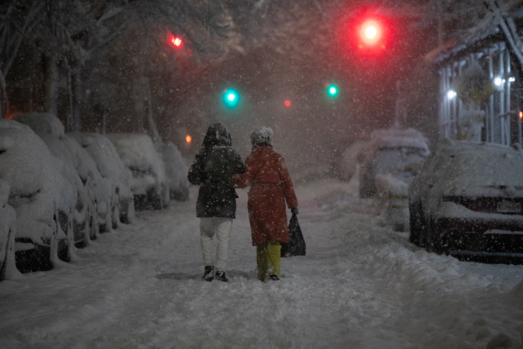 People walk through Fort Greene, Brooklyn as a blizzard descended on the city,