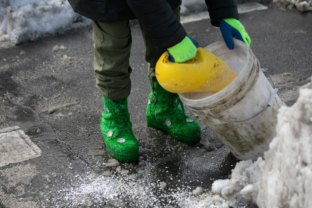 Temporary city worker Mary salts a Sunnyside intersection,