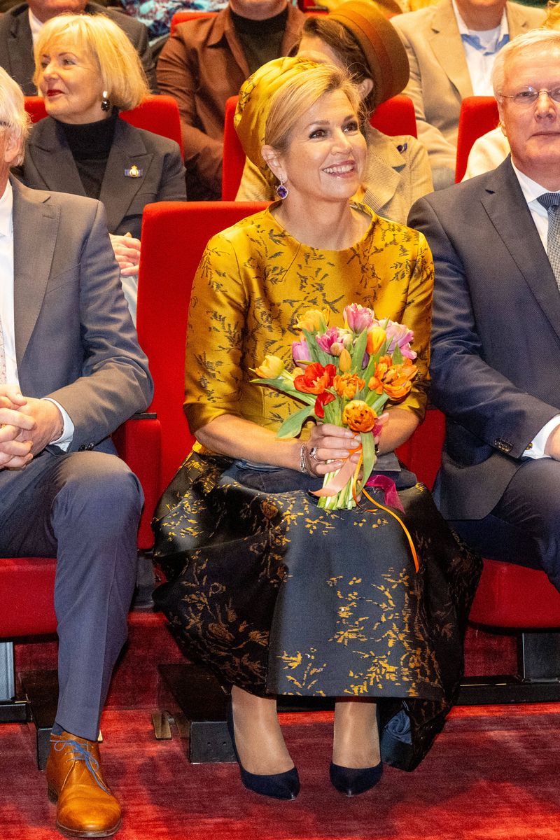 Queen Maxima turned heads in a two-piece outfit featuring a top with a modest bateau neckline, three-quarter sleeves, a subtle peplum flare, structured seams, and a delicate belt.