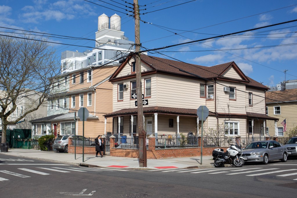 Single-family homes line a residential block in Jamaican.