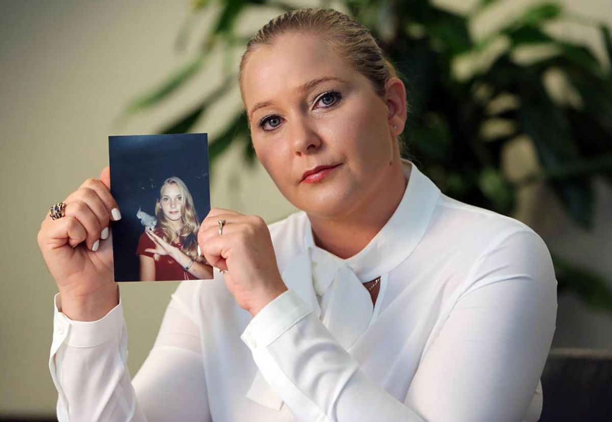 Virginia Roberts Giuffre, with a photo of herself as a teen, when she says she was abused by Jeffrey Epstein, Ghislaine Maxwell and Prince Andrew, among others